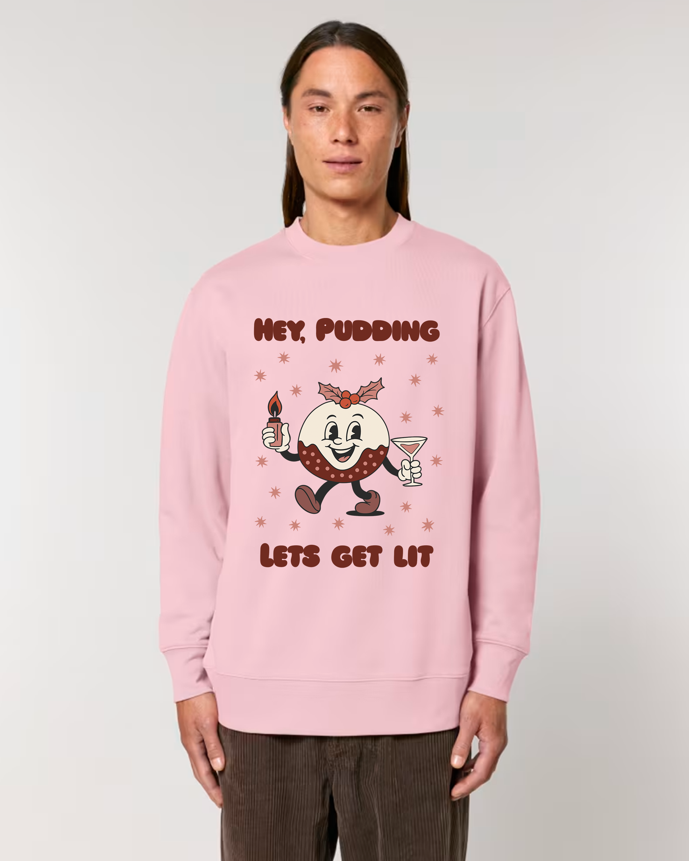 Person wearing a pink sweatshirt with a cartoon character and text on a plain background