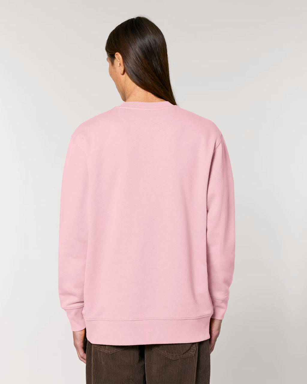 Person wearing a pink sweatshirt against a plain background