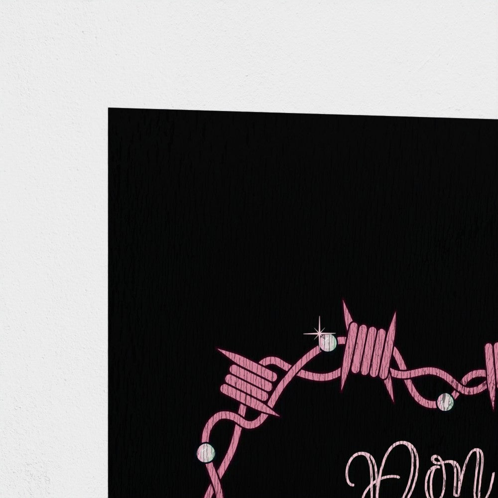 Close-up of a black card with pink barbed wire design and text.