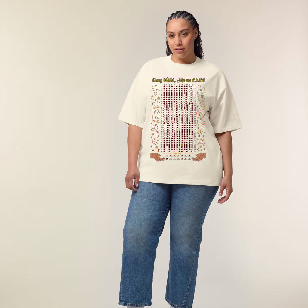 Person wearing a taupe t-shirt with text and graphics, standing against a plain background