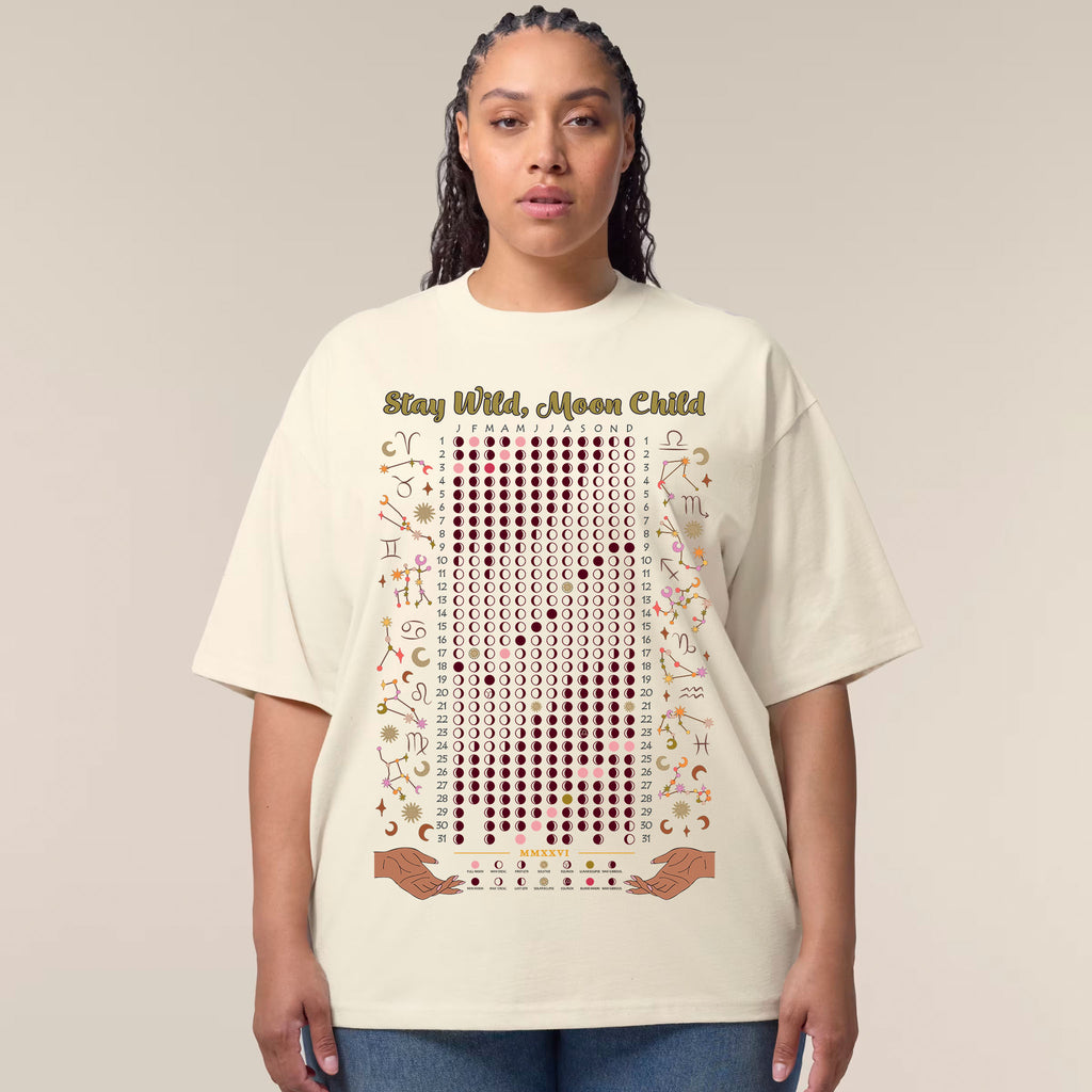 Person wearing a cream t-shirt with text and symbols on a plain background