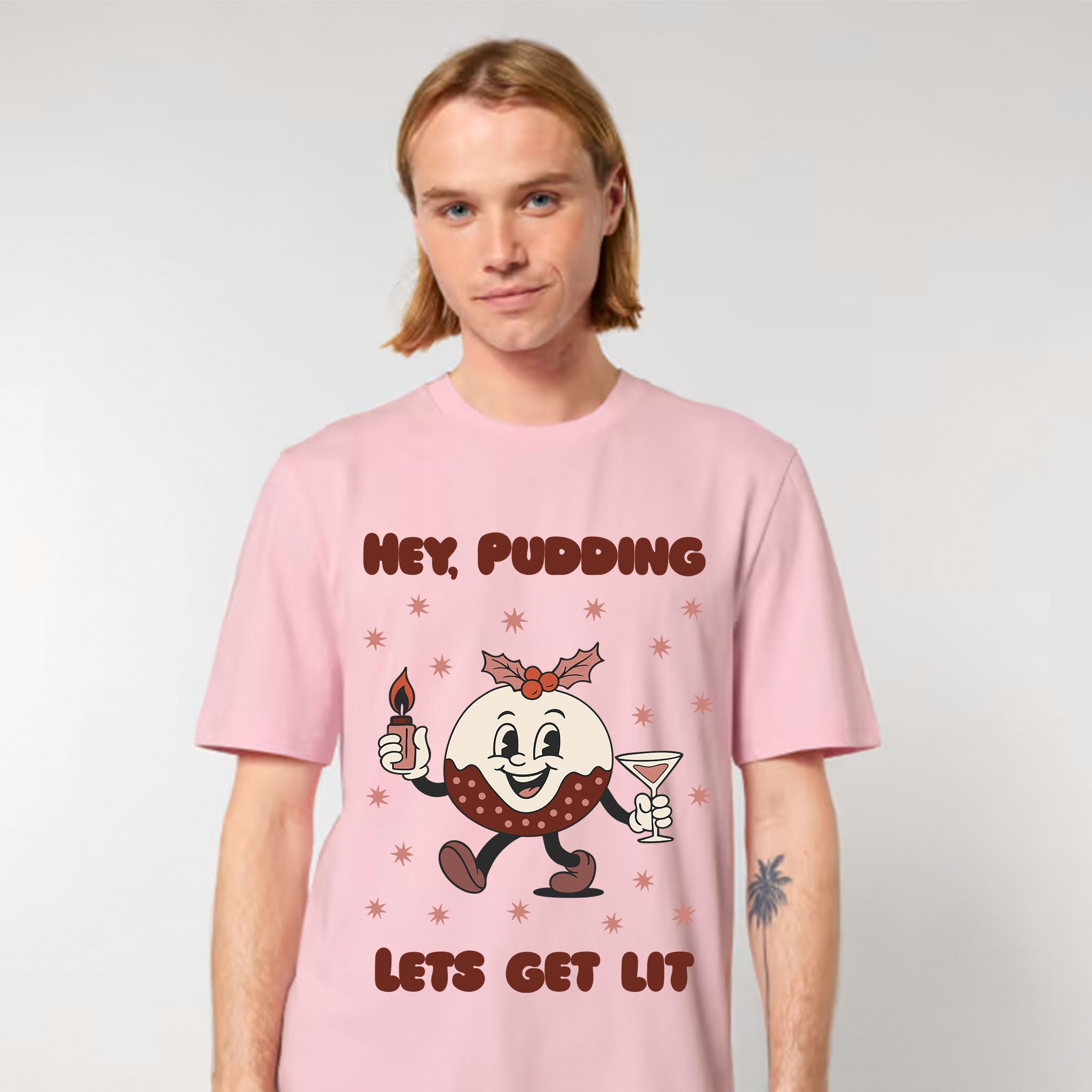 Person wearing a pink t-shirt with a cartoon character and text on a plain background