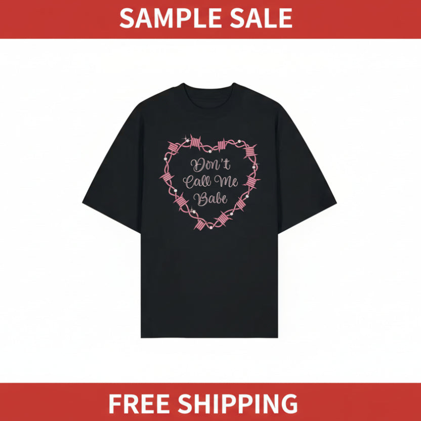 Black t-shirt with pink heart-shaped text design on a white background