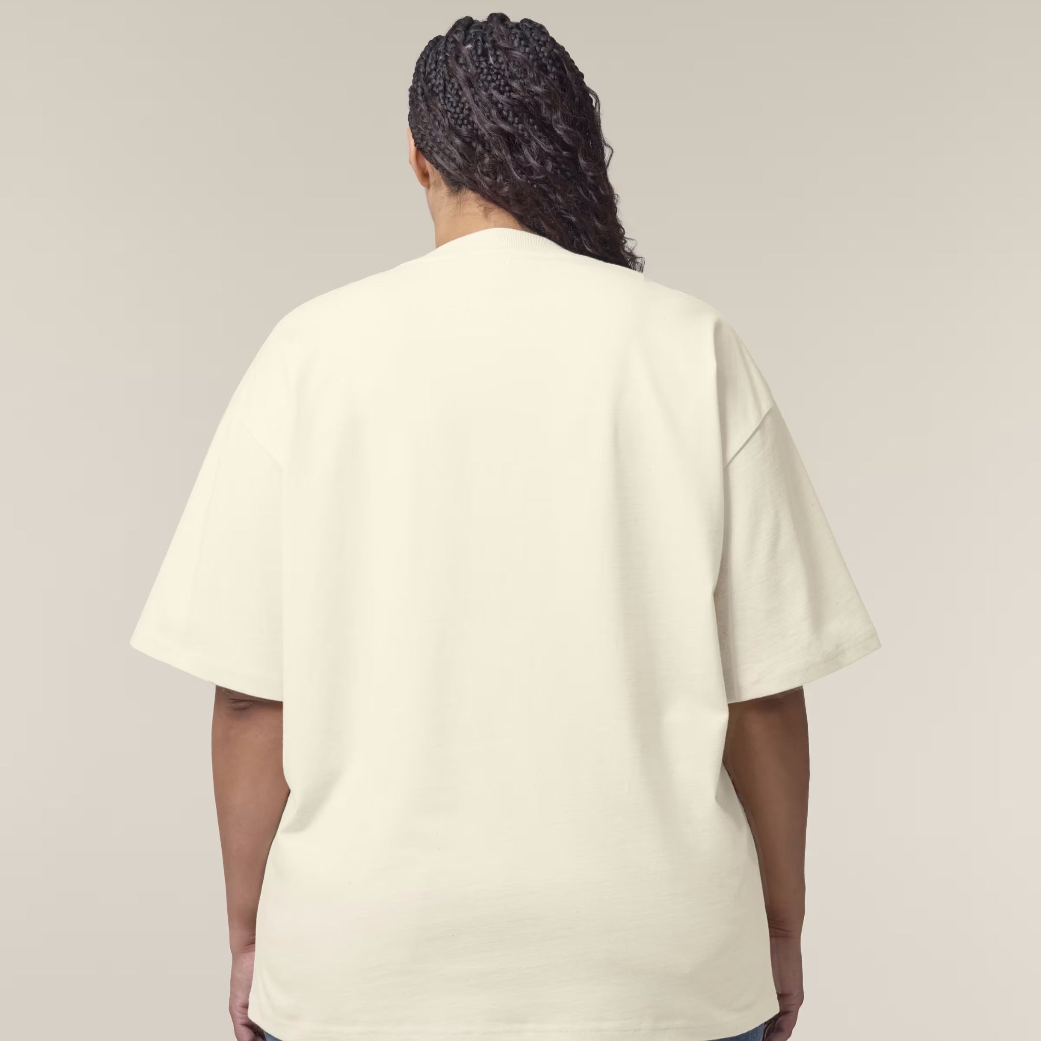 Person wearing a beige t-shirt against a plain background