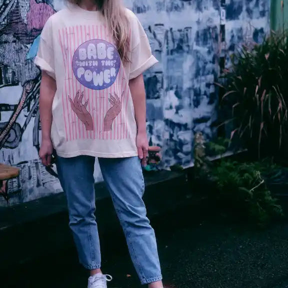 Model wearing a beige t-shirt in an artistic setting