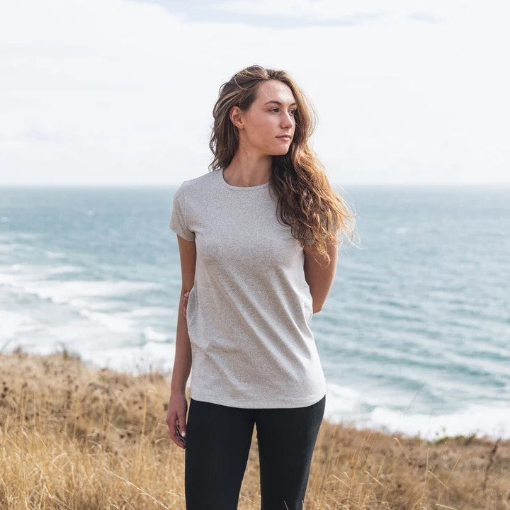woman wearing grey t shirt overlooking the ocean