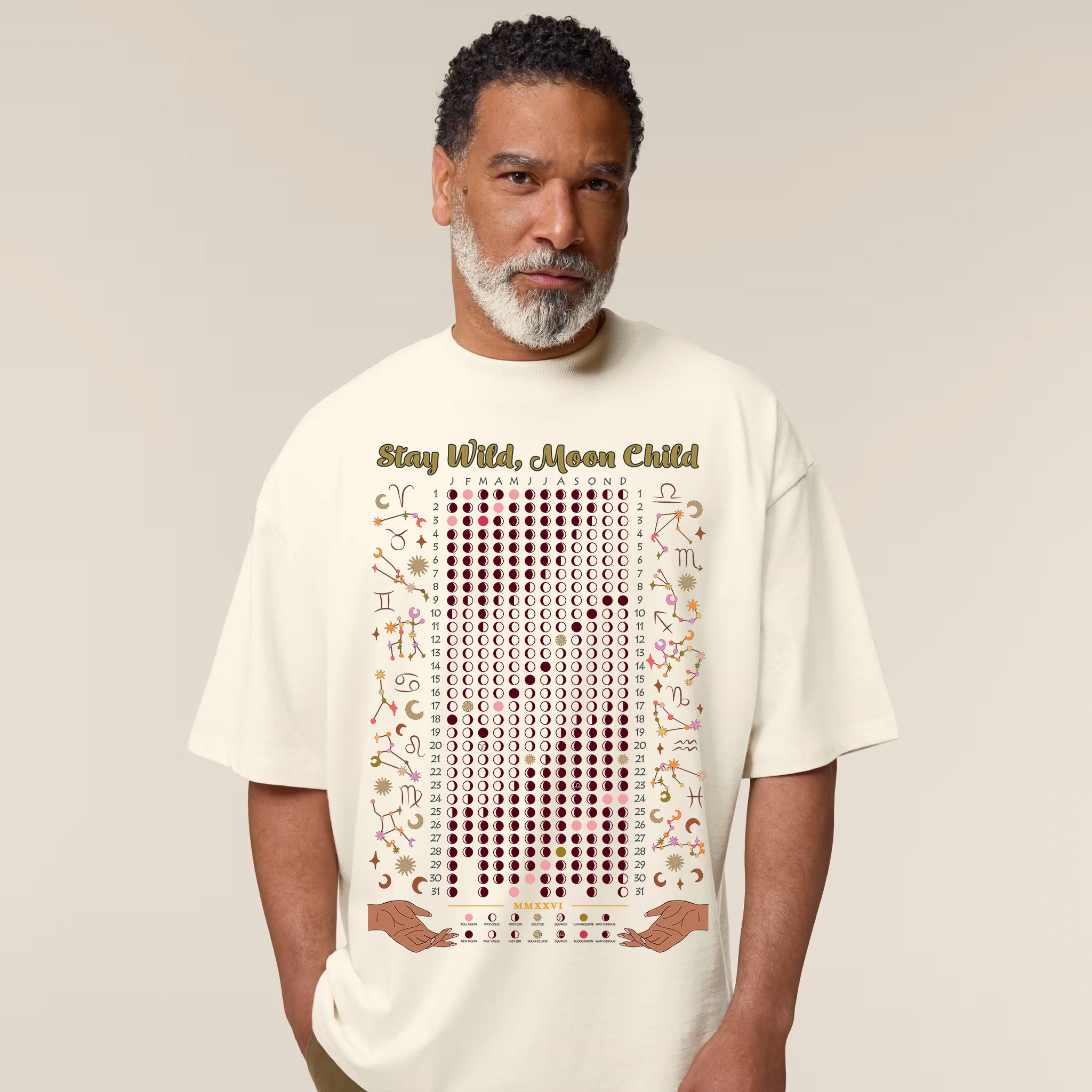 Man wearing a natural t-shirt with a graphic design and text on a plain background