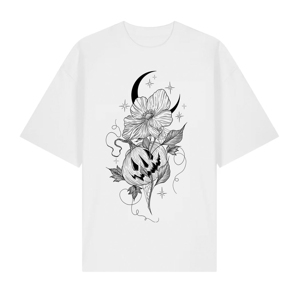 White organic cotton T‑shirt featuring a blackwork tattoo‑style illustration of a crescent moon, flowers, stars, and a carved pumpkin.